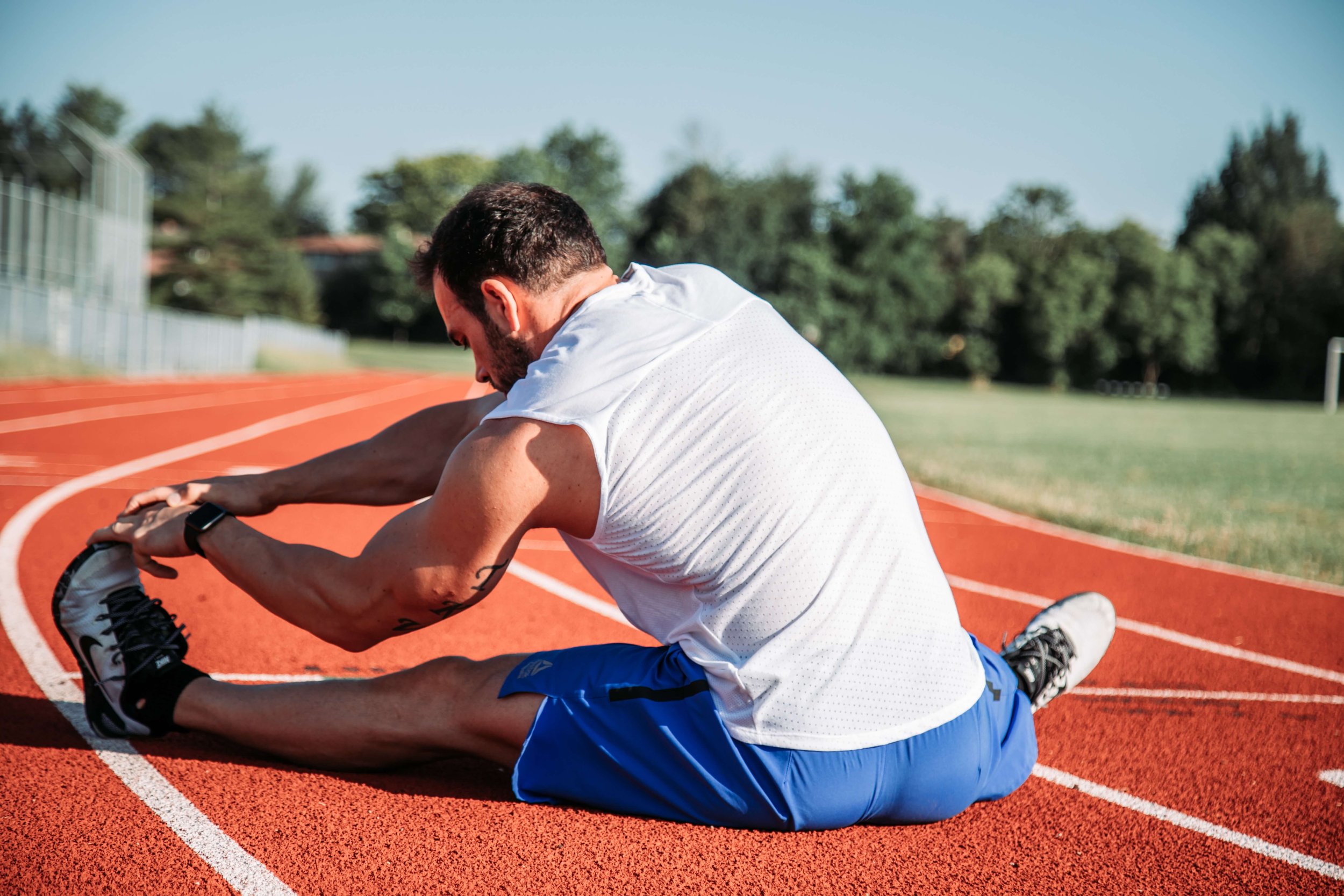 person stretching on a track